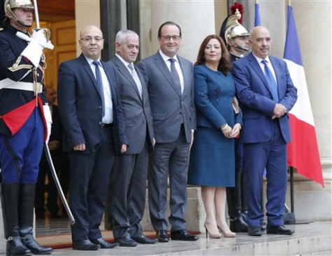 France President Francois Hollande, center, welcomes the four Nobel Peace Prize winners Mohamed Fadhel Mafoudh head of the Tunisian Bar Association, left, Houcine Abassi secretary general of the Tunisian General Labour Union, 2nd left, Wided Bouchamaoui president of the Tunisian employers, 2nd right, and Abdessattar Ben Moussa president of the Tunisian Human Rights League, right, at the Elysee Palace in Paris, France, Friday, Oct. 16, 2015. The 2015 Nobel Peace Prize went to the Tunisian National Dialogue Quartet who steered Tunisia away from civil war and toward democracy after its 2011 revolution. (AP Photo/Michel Euler)