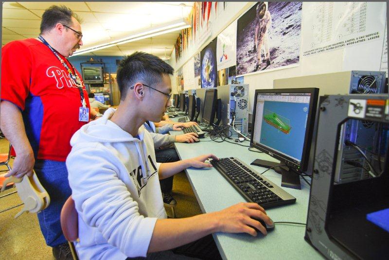 Mr. Curt Reichwein and Ryan Phung work on a 3D printing project as part of the NPHS Technology and Education Depts curriculum. 