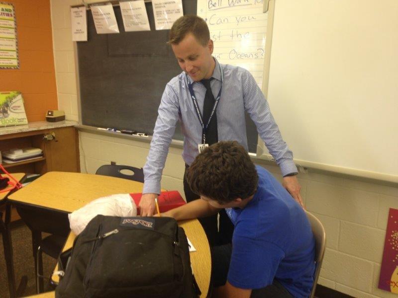 Mr. James Carminito, a new teacher to NPHS in 2014, helps a student during class. 
