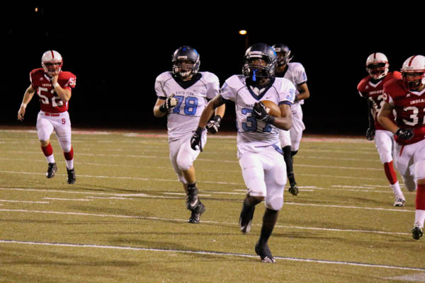 CATCH ME IF YOU CAN: the Knights Deion Robinson carries the ball through Souderton defenders in the Knights 42-7 rout of the Indians on Thursday night.  