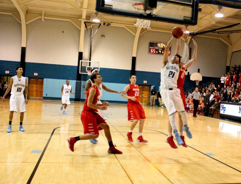 MAD OVER THE START OF HOOPS SEASON- In this file photo, North Penn squares off against Souderton early in the 2013-2014 season, The North Penn Basketball teams will open up their 2014-15 season with a Mid-Knight Madness celebration on December 3rd at 6:30pm at NPHS.