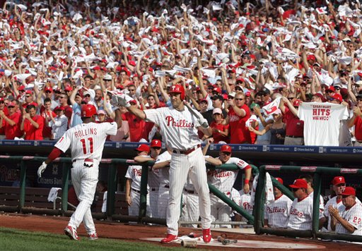 Philadelphia Phillies fans cheer as Pat Burrell, right, greets Jimmy Rollins, after Rollins leadoff one-run home run against the Colorado Rockies, in Game 2 of a National League Division Series playoff baseball game Thursday, Oct. 4, 2007, in Philadelphia. (AP Photo/Rusty Kennedy)
