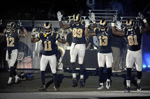 In this Nov. 30, 2014, file photo, St. Louis Rams players, from left; Stedman Bailey (12), Tavon Austin (11), Jared Cook, (89) Chris Givens (13) and Kenny Britt (81) raise their arms in awareness of the events in Ferguson, Mo.,  as they walk onto the field during introductions before an NFL football game against the Oakland Raiders in St. Louis. Perhaps given his extensive experience with law enforcement officials, it shouldnt come as a shock that Britt was the one who lit the spark of player protest against police brutality and civil unrest thats mushroomed across professional leagues as the incidents keep coming. (AP Photo/L.G. Patterson, File)