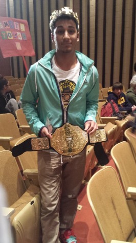 Victor of the individual vocab competition, junior Zaheer Razi, poses with the Vocab Bowl Championship Belt.