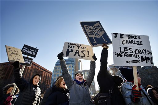 Attendees holds signs and chant the slogan Je Suis Charlie  (I am Charlie) as several hundred people gather in solidarity with victims of two terrorist attacks in Paris, one at the office of weekly newspaper Charlie Hebdo and another at a kosher market, in New Yorks Washington Square Park, Saturday, Jan. 10, 2015. (AP Photo/Jason DeCrow)