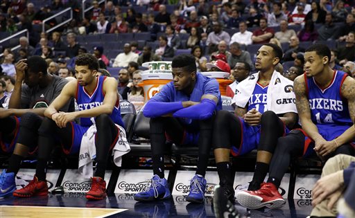 Philadelphia 76ers center Henry Sims, left, guard Michael Carter-Williams, center Nerlens Noel, forward Malcolm Thomas, and guard K.J. McDaniels sit on the bench late in the second half of an NBA basketball game against the Washington Wizards, Monday, Jan. 19, 2015, in Washington. The Wizards won 111-76. (AP Photo/Alex Brandon)