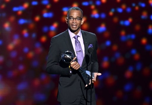 In a July 16, 2014 file photo, sportscaster Stuart Scott accepts the Jimmy V award for perseverance, at the ESPY Awards at the Nokia Theatre, in Los Angeles. Scott, the longtime “SportsCenter” anchor and ESPN personality known for his known for his enthusiasm and ubiquity, died Sunday, Jan. 4, 2015 after a long fight with cancer. He was 49. (Photo by John Shearer/Invision/AP, File)