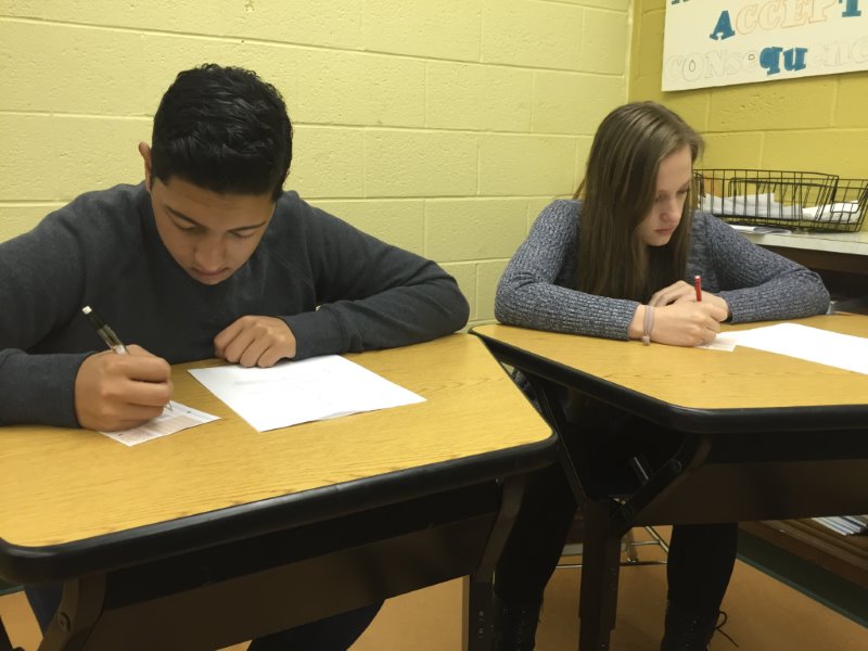 BUBBLING ANSWERS: North Penn High School students Katja Pennypacker (right) and Dillin Bett (left) take a test during class. Multiple choice tests and test prep have, in recent years, become an increasingly prevalent focus in Americas classrooms. 