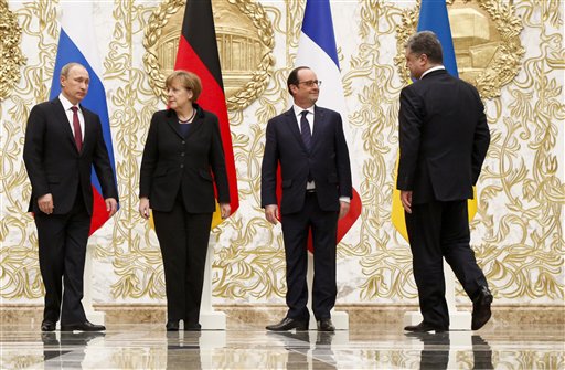 From the left : Russian President Vladimir Putin, German Chancellor Angela Merkel, French President Francois Hollande, and Ukrainian President Petro Poroshenko arrive to pose for a photo during a time-break in their peace talks in Minsk, Belarus, Wednesday, Feb. 11, 2015. Leaders of Russia, Ukraine, France and Germany are gathering for crucial talks in the hope of negotiating an end fighting between Russia-backed separatist and government forces in eastern Ukraine. (AP Photo/Alexander Zemlianichenko)