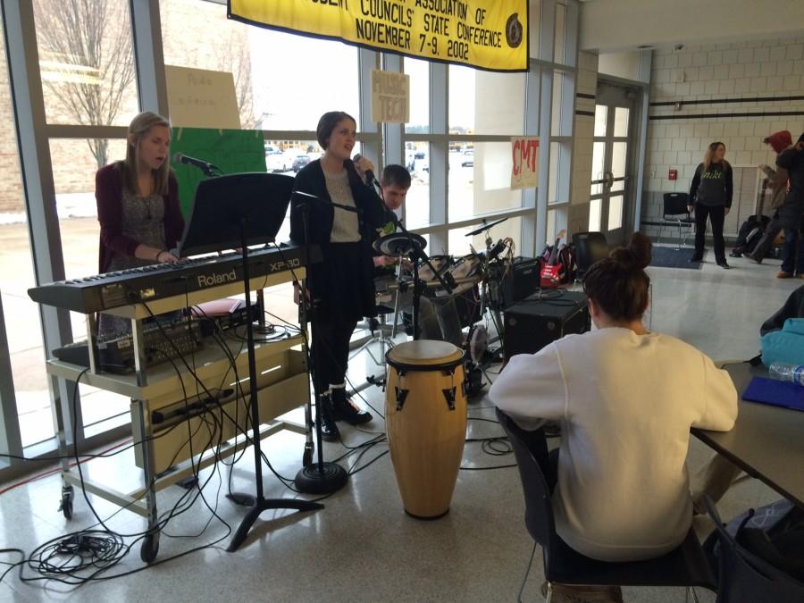 Students in CMT perform in the senior cafe in front of students.