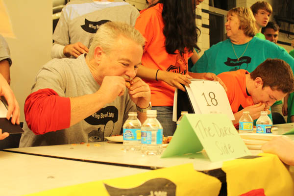WING MAN- NPHS Principal Burt Hynes gobbles down some wings during the 2015 SGA sponsored Wing Bowl. Hynes and the admin team The Dark Side were crowned Wing Bowl champs.
