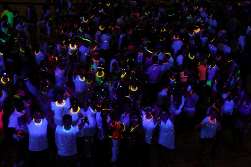 Students crowd North Penns gymnasium for a night of informal fun at the annual Knight Glo dance for charity.