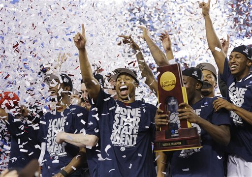 Connecticut celebrates with the championship trophy after beating Kentucky 60-54 at the NCAA Final Four tournament college basketball championship game Monday, April 7, 2014, in Arlington, Texas. (AP Photo/David J. Phillip)