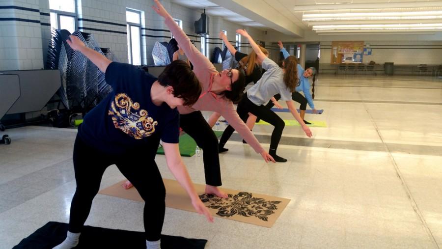 Several members of North Penn High Schools newly-created Yoga Club warm up with one of their favorite poses before their meeting begins.