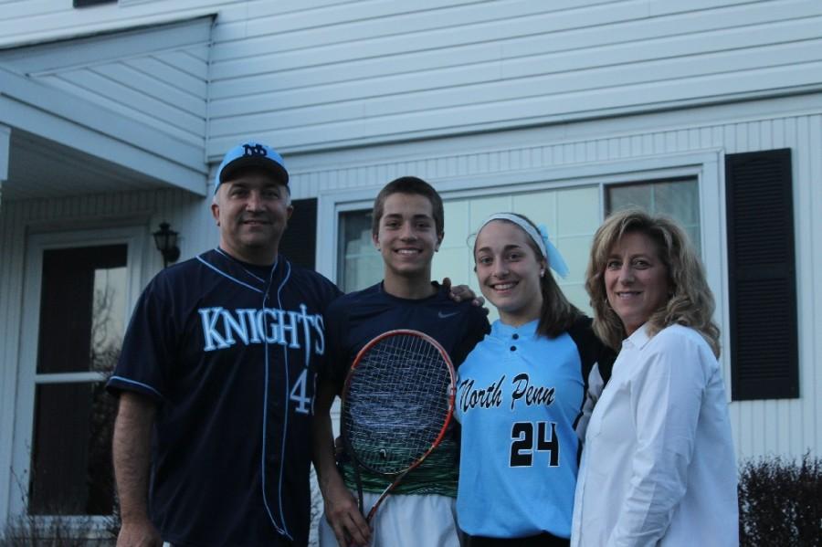 From left, Frank, Frankie, Nicole, and Colleen Yanni pose with the emblems of the sports they work so hard to continue in spite of injuries and setbacks.