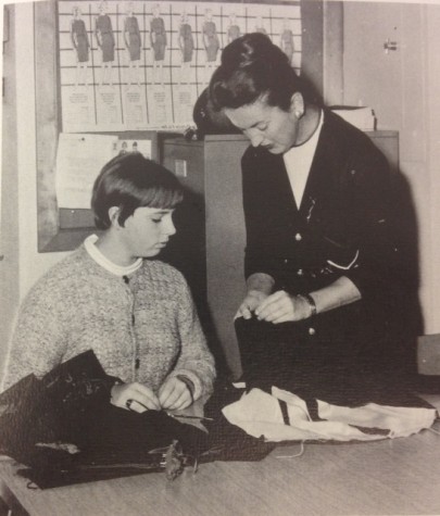 Homemaking Department Chairman Jean Buck oversees the fabrication of a dress. Buck also was the director of the Usherettes.