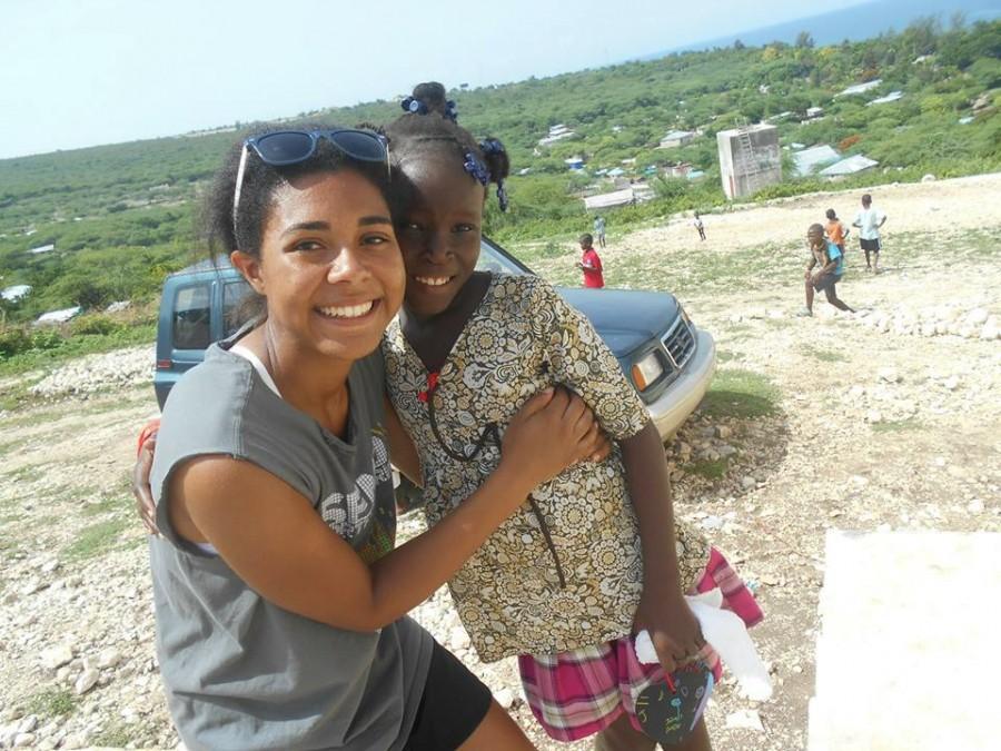 HELPING OTHERS: NPHS senior, Danielle Somerville, poses with a child she met in Haiti.