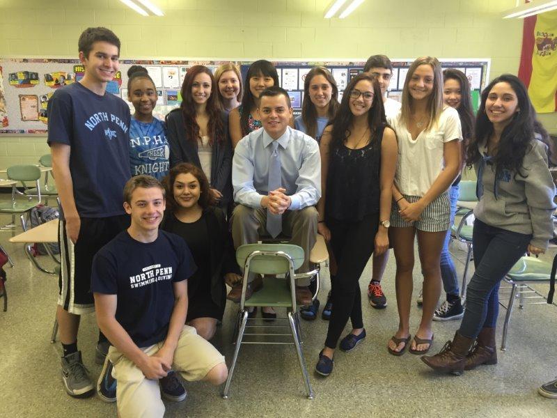 Hola! North Penn High School Spanish teacher, Alejandro Vidal poses with some of his Spanish students.
