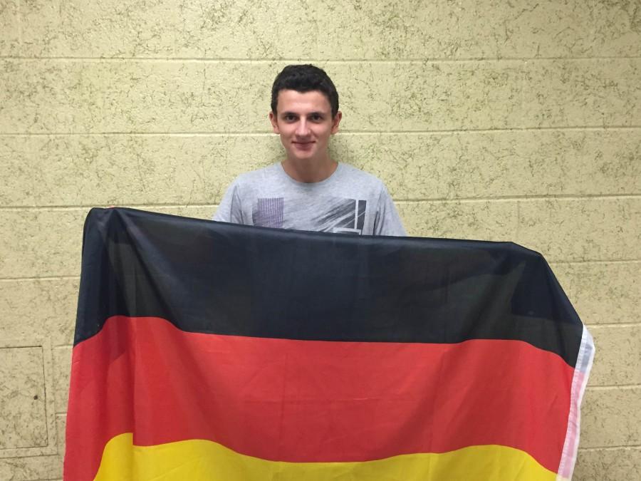 Exchange student Jakob Traub proudly holds up the flag of his native country, Germany.