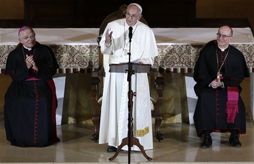 As Archbishop Charles Chaput, left, and Bishop Timothy Senior, right, listen, Pope Francis, center,  addresses a gathering in Saint Martins Chapel at St. Charles Borromeo Seminary Sunday, Sept. 27, 2015, in Wynnewood, Pa. (AP Photo/Mel Evans)