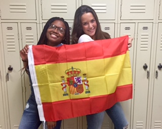 Jimena Gallo, right, and former North Penn exchange student, Ke’Nia Washington, left, pose with the Spanish flag.