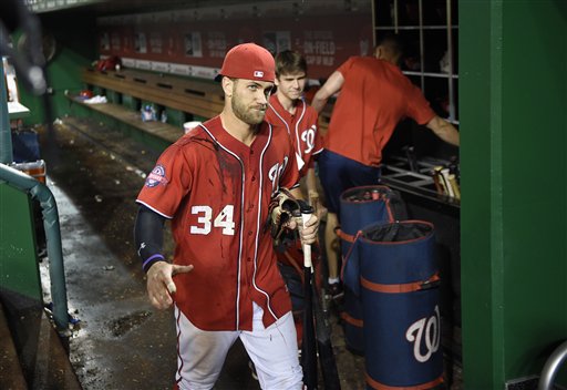Washington Nationals Bryce Harper (34) gestures and walks along the dugout after a baseball game against the Philadelphia Phillies, Saturday, Sept. 26, 2015, in Washington. Harper drove in the game-winning run as the Nationals won 2-1 in 12 innings. (AP Photo/Nick Wass)