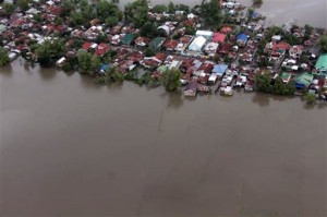 In this photo provided by the Philippine Air Force, houses and rice fields are inundated by floodwaters in northern Philippines Tuesday, Oct. 20, 2015. Tropical Storm Koppu finally blew away from the main northern Philippine island Tuesday, after leaving several dead over the weekend and forcing tens of thousands of villagers into emergency shelters and destroying rice fields ready for harvest. 
