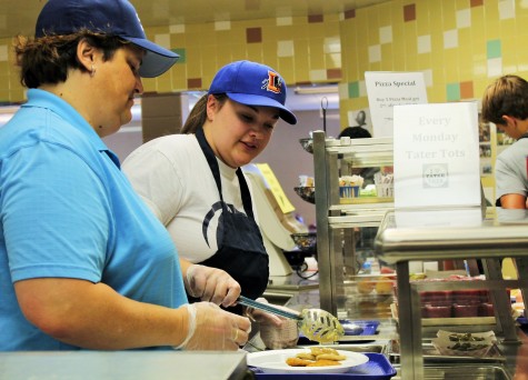 As Bonnie Carter, a NPHS substitute cafeteria worker, put the chicken tenders on the tray, Madison had to scoop six pierogies on to the tray. Madison also scooped the green beans for the students upon request.