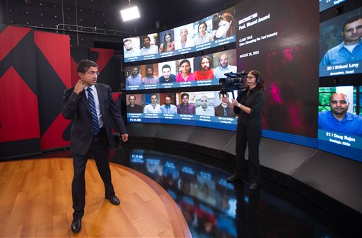 Harvard Business School Professor and faculty chair of HBX Bharat Anand demonstrates HBX Live, an online classroom that allows real-time interaction between professors and students from around the world, at the WGBH television studios in Boston, Friday, Aug. 21, 2015. (AP Photo/Gretchen Ertl)