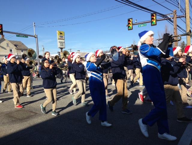 Members of the North Penn marching band play holiday favorites as they march down Main Street during Saturdays Mardi Gras parade