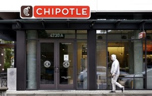 A pedestrian walks past a closed Chipotle restaurant Monday, Nov. 2, 2015, in Seattle. An E. coli outbreak linked to Chipotle restaurants in Washington state and Oregon has sickened nearly two dozen people in the third outbreak of foodborne illness at the popular chain this year. Cases of the bacterial illness were traced to six of the fast-casual Mexican food restaurants, but the company voluntarily closed down 43 of its locations in the two states as a precaution. 
