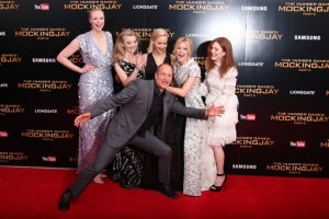 From top left, Gwendoline Christie, Natalie Dormer, Jennifer Lawrence, Elizabeth Banks, Julianne Moore and Woody Harrelson, foreground, pose for photographers upon arrival at the premiere of the film 'The Hunger Games Mockingjay Part 2', in London, Thursday, Nov. 5, 2015. 