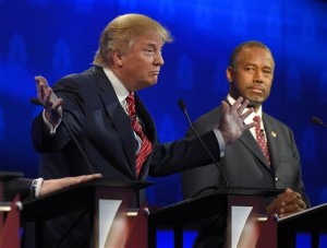 Ben Carson, right, watches as Donald Trump speaks during the CNBC Republican presidential debate at the University of Colorado, Wednesday, Oct. 28, 2015, in Boulder, Colo. 