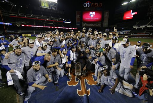 Kansas City Royals pose with World Series trophy after Game 5 of the Major League Baseball World Series against the New York Mets Monday, Nov. 2, 2015, in New York. The Royals won 7-2 to win the series. 