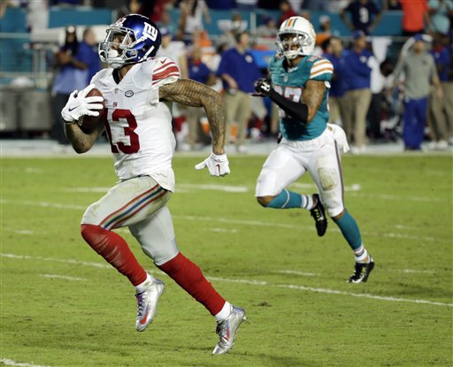 New York Giants wide receiver Odell Beckham (13) runs for a touchdown during the second half of an NFL football gam against the Miami Dolphins, Monday, Dec. 14, 2015, in Miami Gardens, Fla.  (AP Photo/Wilfredo Lee)