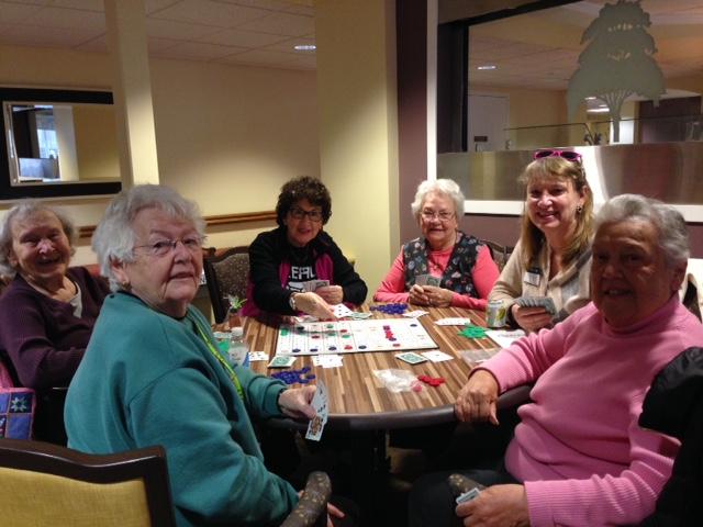 Residents of Elm Terrace Gardens take a break from a game of Sequence. Elm Terrace is actively seeking high school students who are interested in volunteering time with Elm Terrace Gardens residents. 