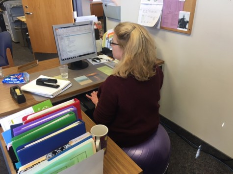 Secretary Joanne Borchers is poised for a productive day of good posture and good health as she works at her desk on Wednesday morning at North Penn High School.