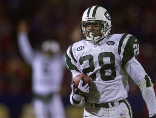 New York Jets running back Curtis Martin scrambles to the end zone to score against the New England Patriots during the second quarter of their AFC East Conference game at Foxboro Stadium in Foxboro, Mass., Monday Nov. 15, 1999.  In the distant background is Jets quarterback Ray Lucas. Even though his team has plummeted to the bottom of its division, Curtis Martin has been surging toward the top of the NFL rushing charts. (AP Photo/Charles Krupa)