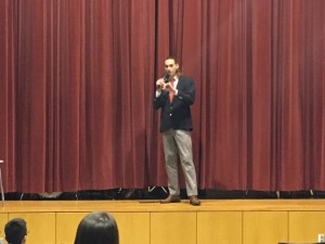 Josiah Zulauf stands on the audion stage giving his final speech for public speaking.