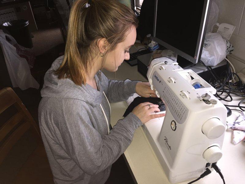 Fashion student Heather Cunningham sews fabric during class. 