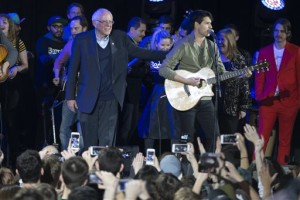 Democratic presidential candidate Sen. Bernie Sanders, I-Vt., left, stands with Vampire Weekend lead singer Ezra Koenig during a campaign rally at the University of Iowa, Saturday, Jan. 30, 2016, in Iowa City, Iowa. (AP Photo/Evan Vucci)