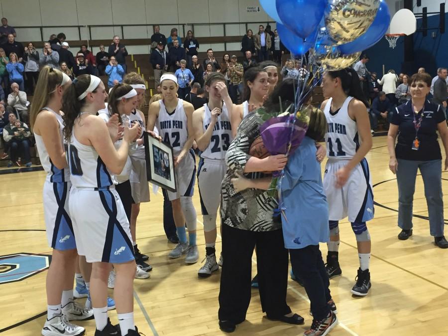 Surrounded+by+her+team%2C+girls+basketball+coach+Maggie+deMarteleire+embraces+team+manager+Rachel+Grace+following+the+coachs+500th+career+win.