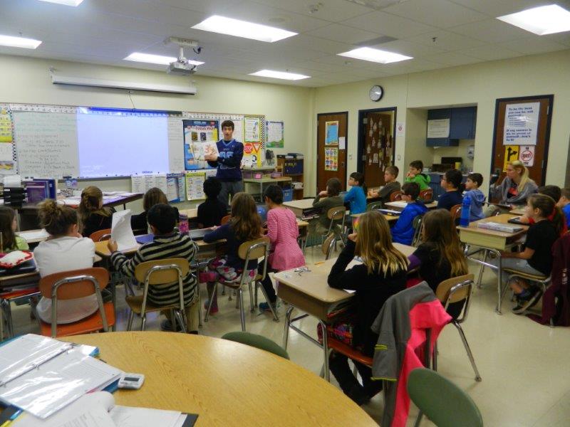 NP football player Ben Dogunniuck reads to students at General Nash as part of the annual Reading Super Bowl.