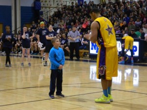Harlem Wizards shenanigans often include getting young crowd members involved in the action as shown here.