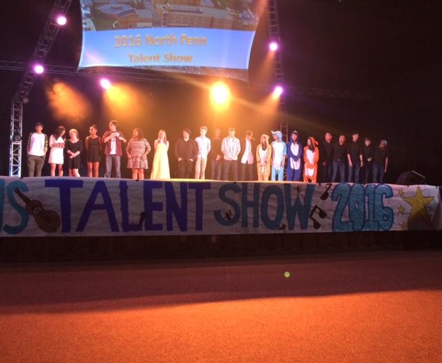 Talent show contestants line up on stage as they wait for the winners to be announced at the end of the show. 