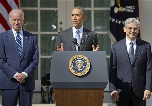 Federal appeals court judge Merrick Garland, right, stands with President Barack Obama and Vice President Joe Biden as he is introduced as Obamas nominee for the Supreme Court. (AP Photo/Pablo Martinez Monsivais)