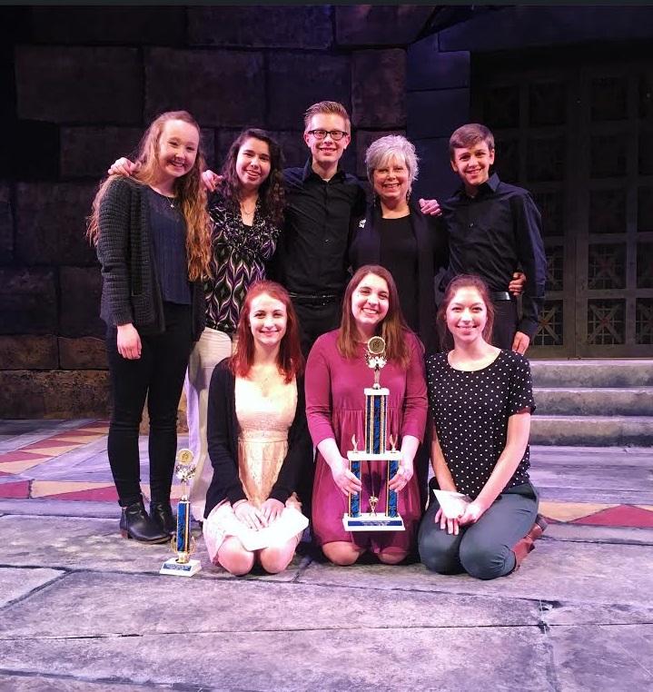 (Bottom row) Abriel Smith, Elizabeth Jebran, and Catherine Winner (Top row) Maura Slater, Elizabeth Tyree, Liam McKee, Mrs. Andrea Roney, and Dan Wescoe pose with their first place and individual trophies following Satudays Shakespeare competition at DeSales.