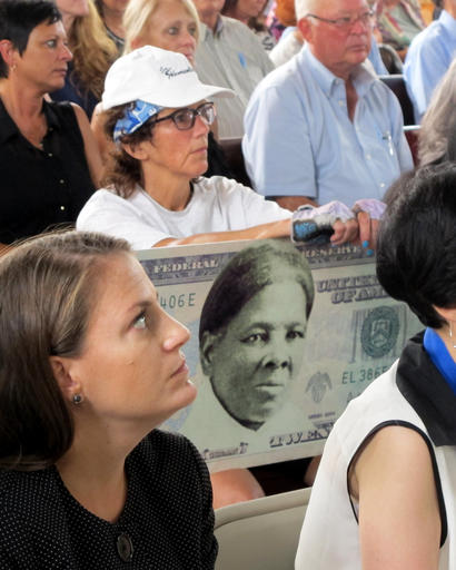 In this Monday, Aug. 31, 2015, file photo, a woman holds a sign supporting Harriet Tubman for the $20 bill during a town hall meeting at the Womens Rights National Historical Park in Seneca Falls, N.Y. A Treasury official said Wednesday, April 20, 2016, that Secretary Jacob Lew has decided to put Harriet Tubman on the $20 bill, making her the first woman on U.S. paper currency in 100 years. (AP Photo/Carolyn Thompson, File)
