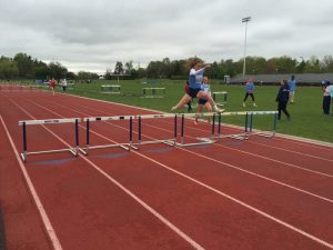 Captain Morgan Brett jumps over the final hurdles as she heads towards the finish line.