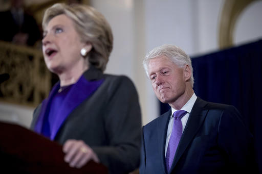 Former President Bill Clinton listens as his wife, Hillary Clinton, speaks to staff and supporters at the New Yorker Hotel in New York, Wednesday, Nov. 9, 2016, where she conceded her defeat to Republican Donald Trump after the hard-fought presidential election.  (AP Photo/Andrew Harnik)